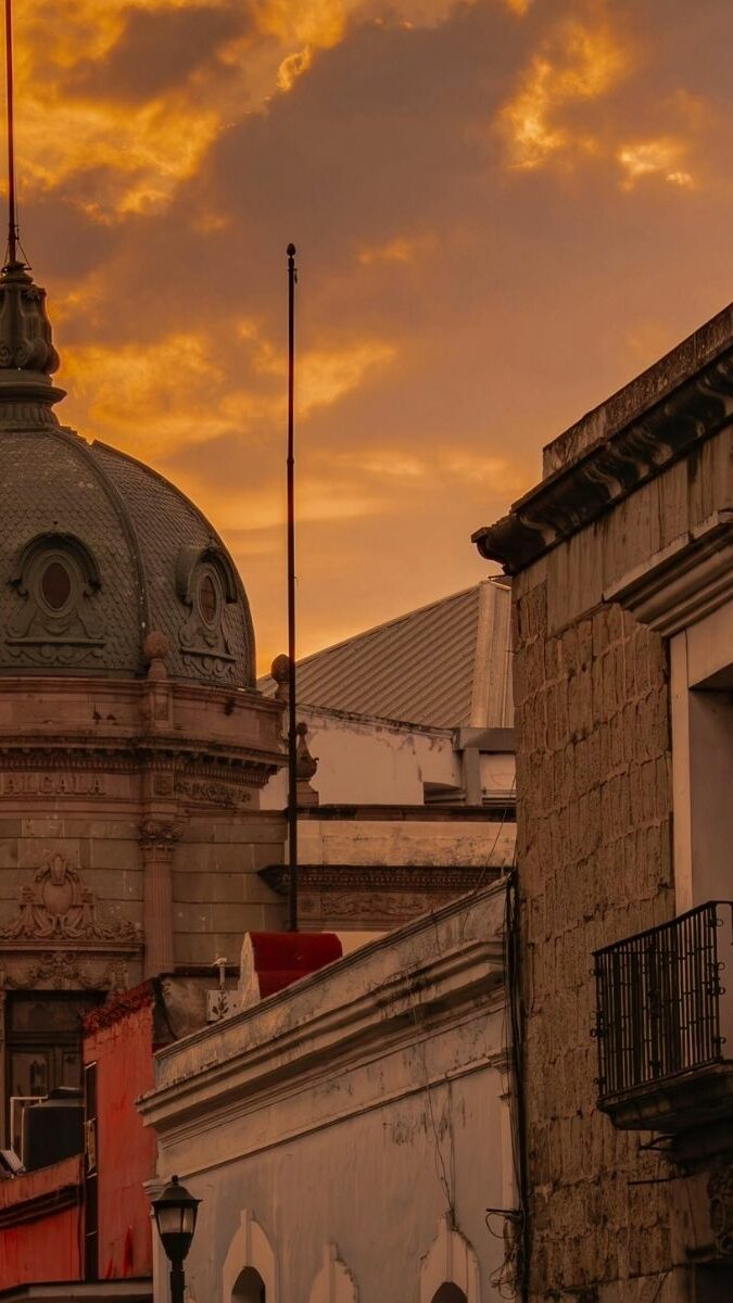 Dôme d'une église coloniale au coucher du soleil à Oaxaca avec ciel orangé
